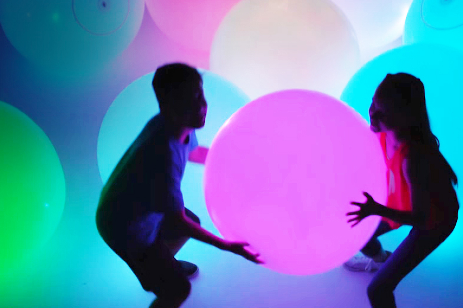 two kids playing colorful wubble ball